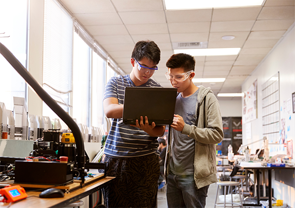 STEM students looking at laptop
